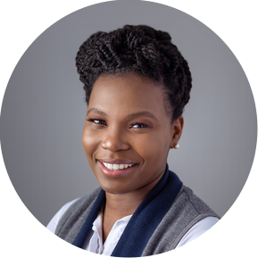 Corporate headshot of a lady smiling against a grey backdrop.
