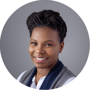 Corporate headshot of a lady smiling against a grey backdrop.