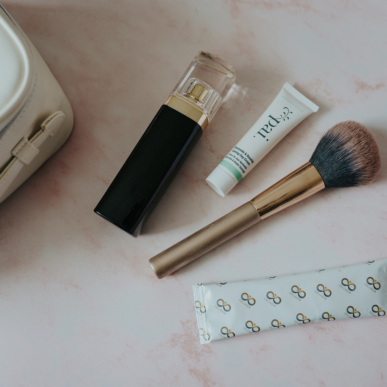 Product photography. Collagem sachet amongst makeup and skincare products.