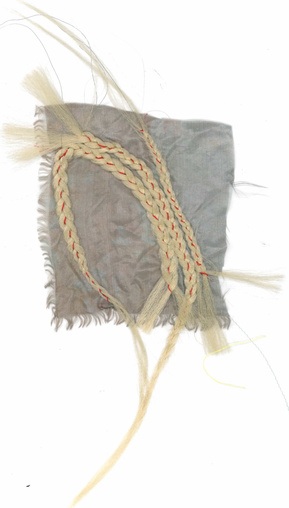 Blonde braids sewn on silk fabric.