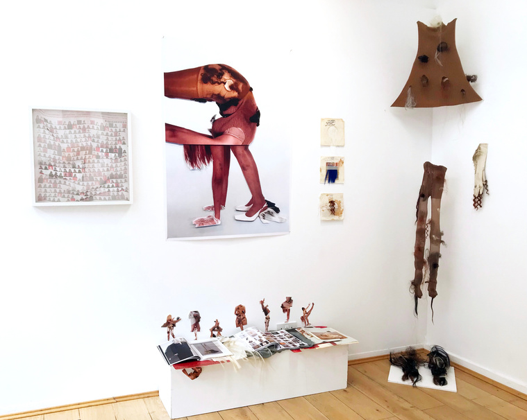 An exhibition of display of hair, clothes, collages, books, a framed digital print fabric in The Brick Lane Gallery, London.