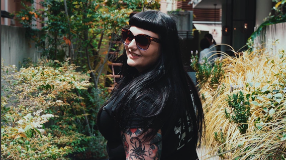 Photo of me in a green space looking over my shoulder and smiling.