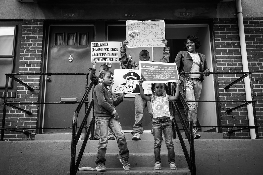 Kids outside of the Gilmore projects , home of Freddie Gray, prepare for a peaceful march in Baltimore.