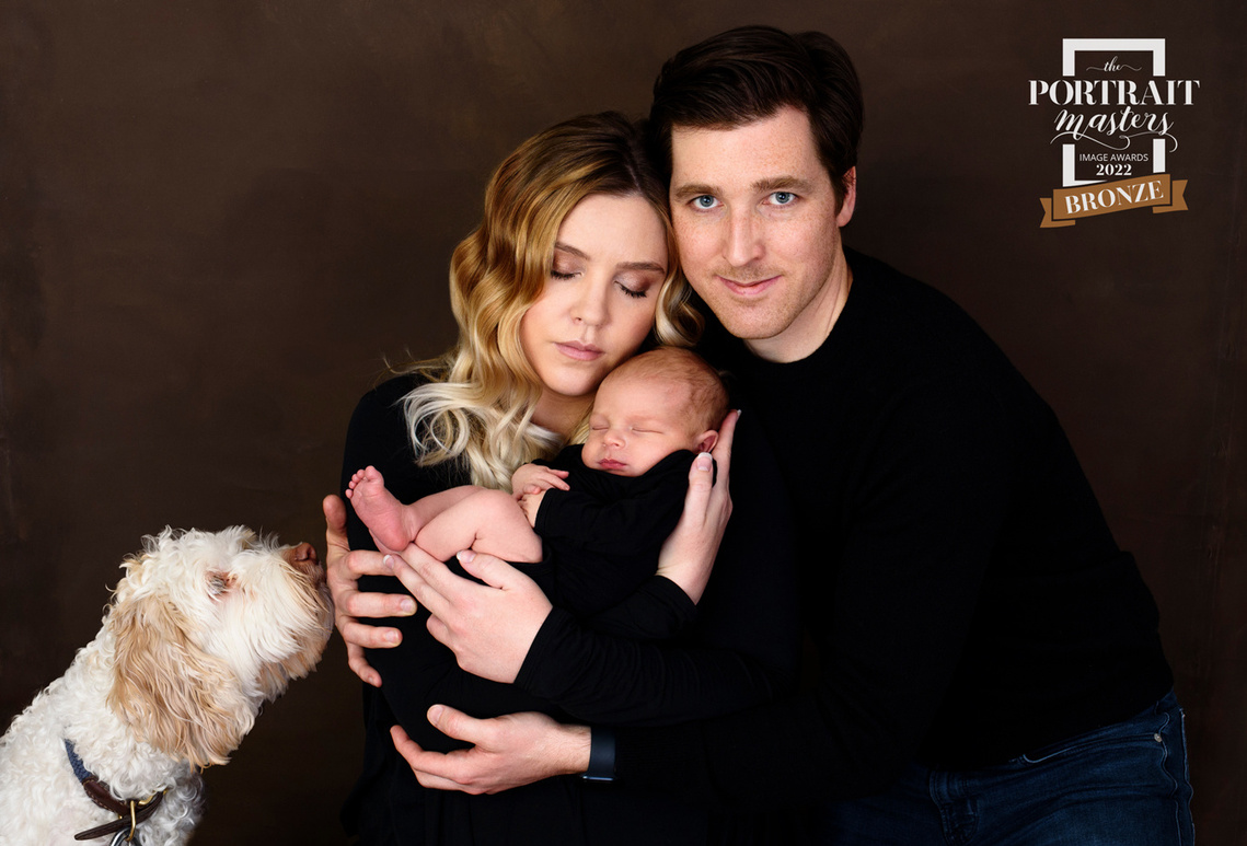 Bronze Image Award from the Portrait Masters 2022 for this family portrait including the parents, the newborn baby and their dog, all shot in my studio in Chêne-Bougeries.