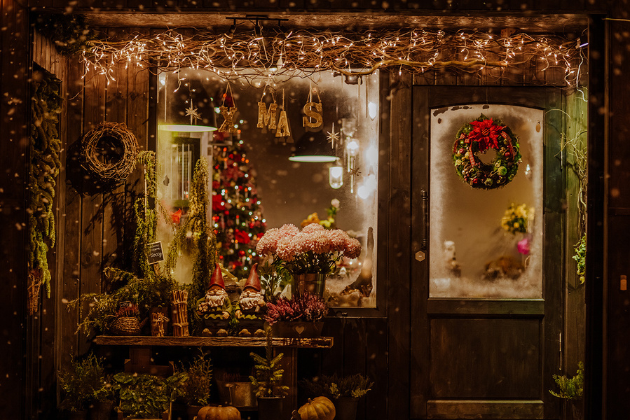 A tasteful, colourful, cosy mountain inspired Christmas chalet shop window, serving as a composite for your seasonal winter family portrait. I take your portraits in my studio, you choose the composite you love most.