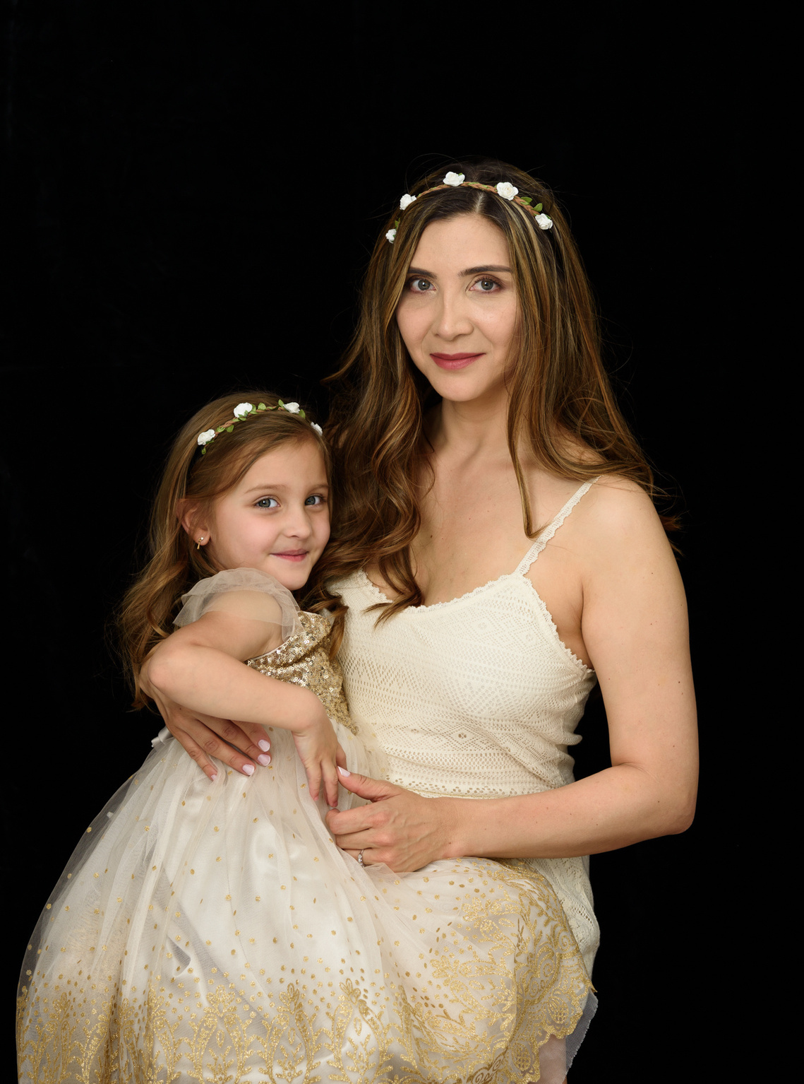 Fine-art Mummy and Me portrait. Mother photographed with her daughter, both wearing cream coloured dresses and flowered headbands. We created Mummy and Me portraits to treasure as Wall Art to remind the family everyday of their love for each other.