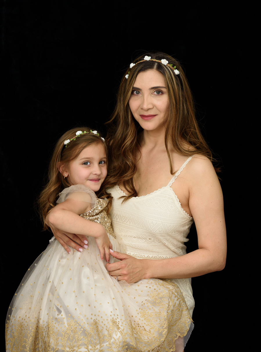 Portrait of a mother with her daughter taken in the studio. Both are dressed in similar clothes. Mummy and Me Photo Sessions available at https://www.helenputsman.com/