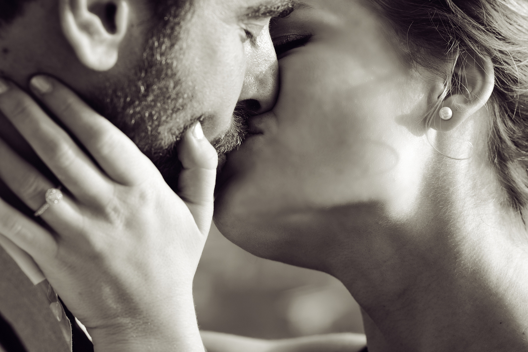''The Kiss''. Engaged couple embrace.