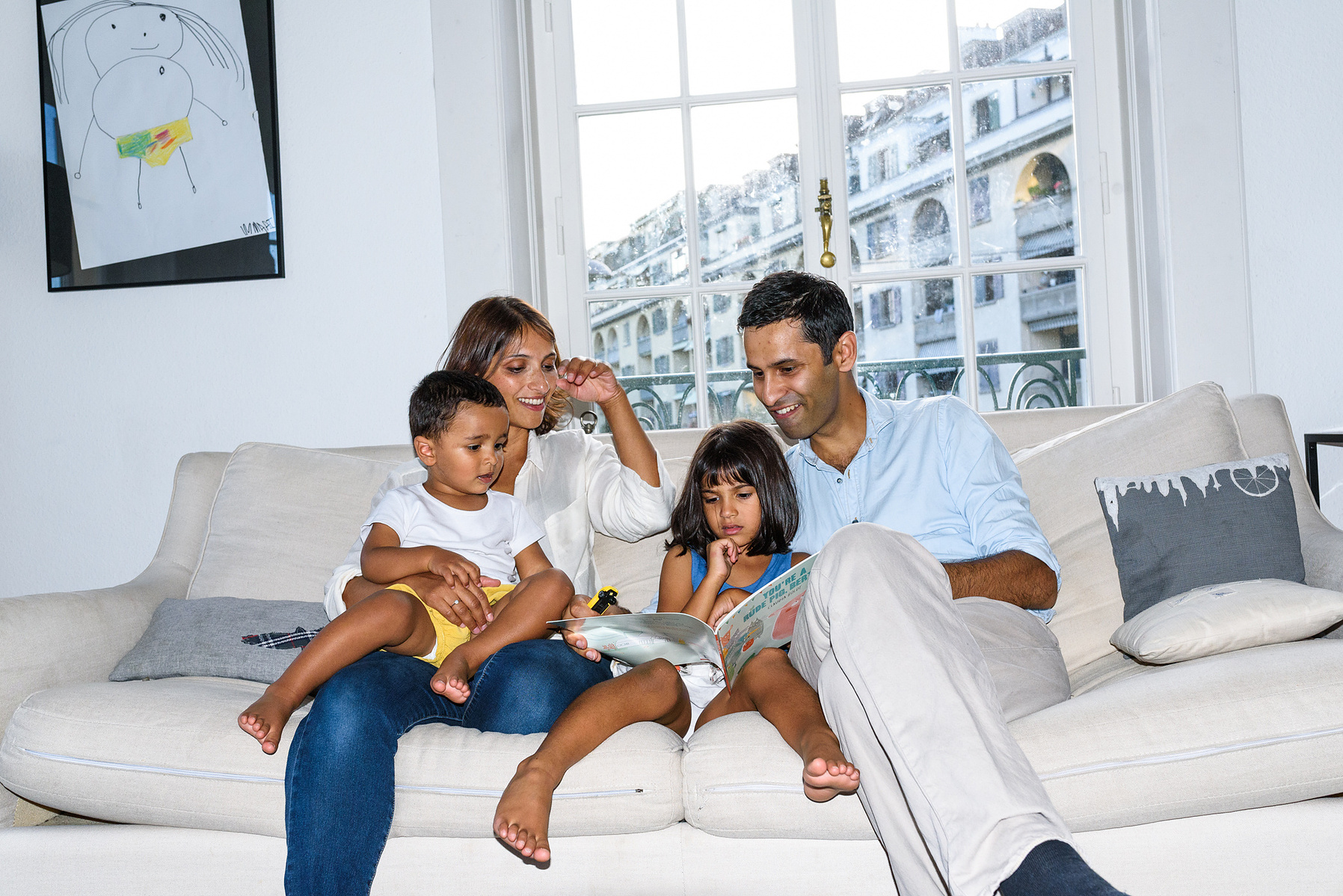 I captured the family relaxed, on their sofa at home, in a typical scene with the father reading to the kids. Shot in Geneva, Switzerland.