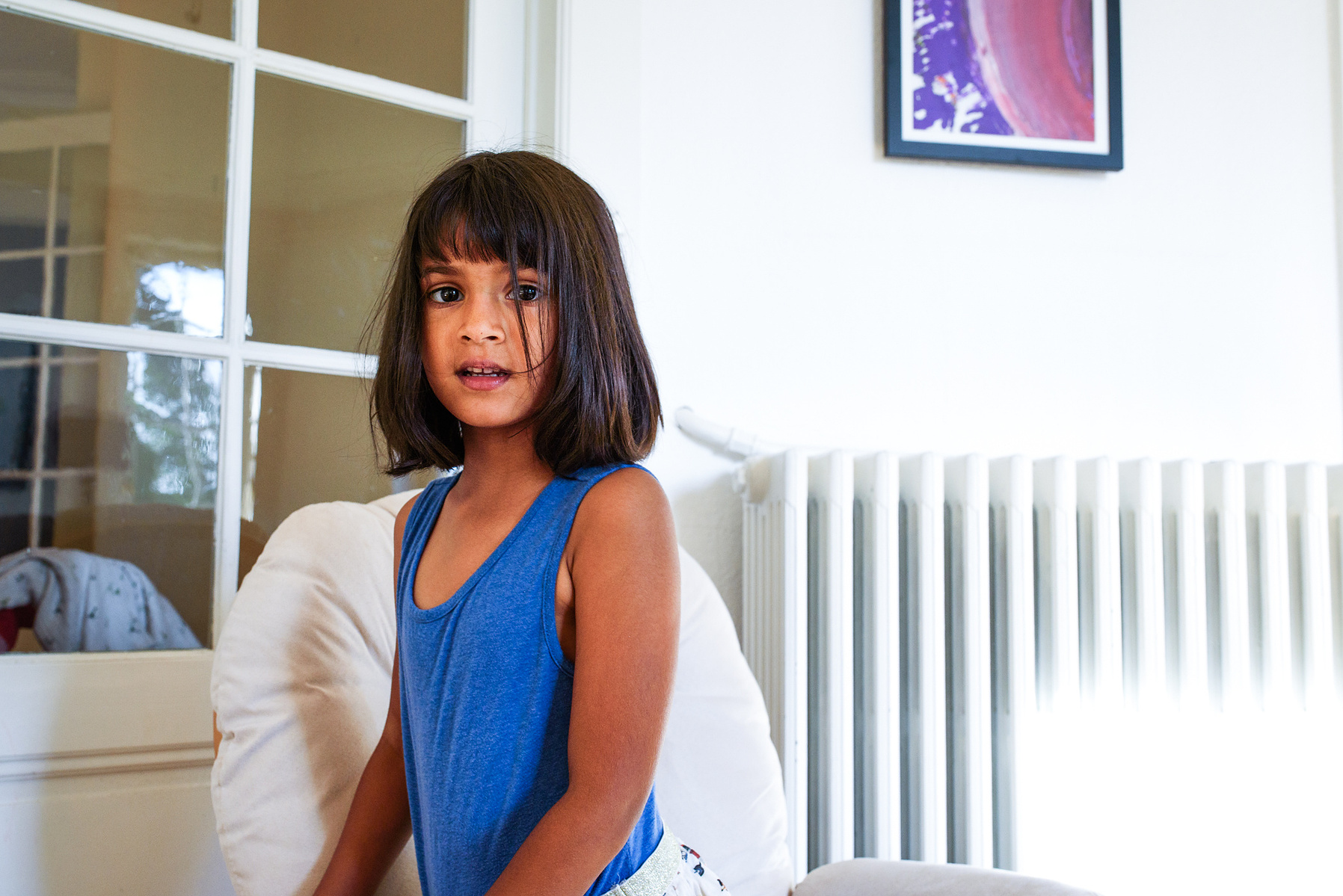 Portrait of child taken during lifestyle portrait session shot at the client's home in Geneva.