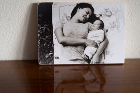 A portrait of a newborn baby taken outside with his sister on a family blanket. Shot in Parc des Eaux-Vives and printed onto a Photoblock.