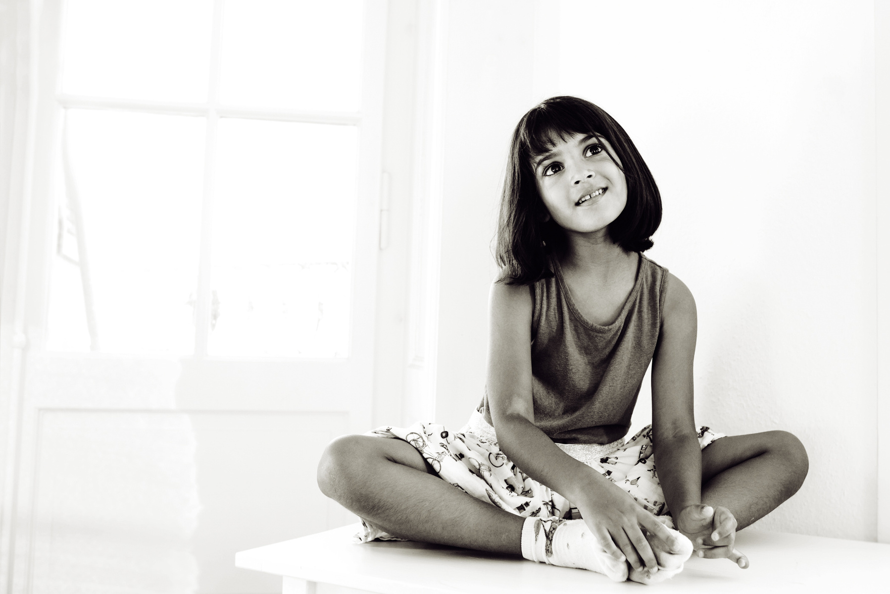 Portrait of child taken during lifestyle portrait session shot at the client's home in Geneva. This girl has a real dream-like quality to her.