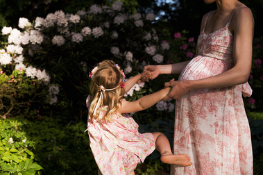 Dressed in matching fabric, dancing among spring blooms — a mother, her daughter, and the baby boy they are both already so in love with. Celebrating motherhood's journey, one precious moment at a time.