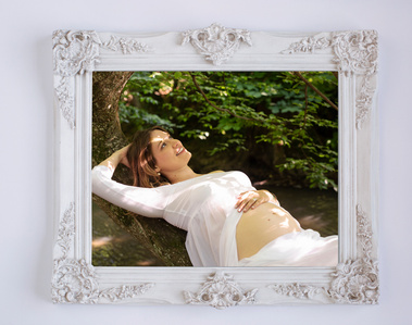 There is a particular stillness to these weeks. Here, beside the Seymaz river in Chêne-Bougeries, a young mother-to-be pauses in that quiet space between who she was and who she is becoming. Fine-art print shown inside white decorative frame.