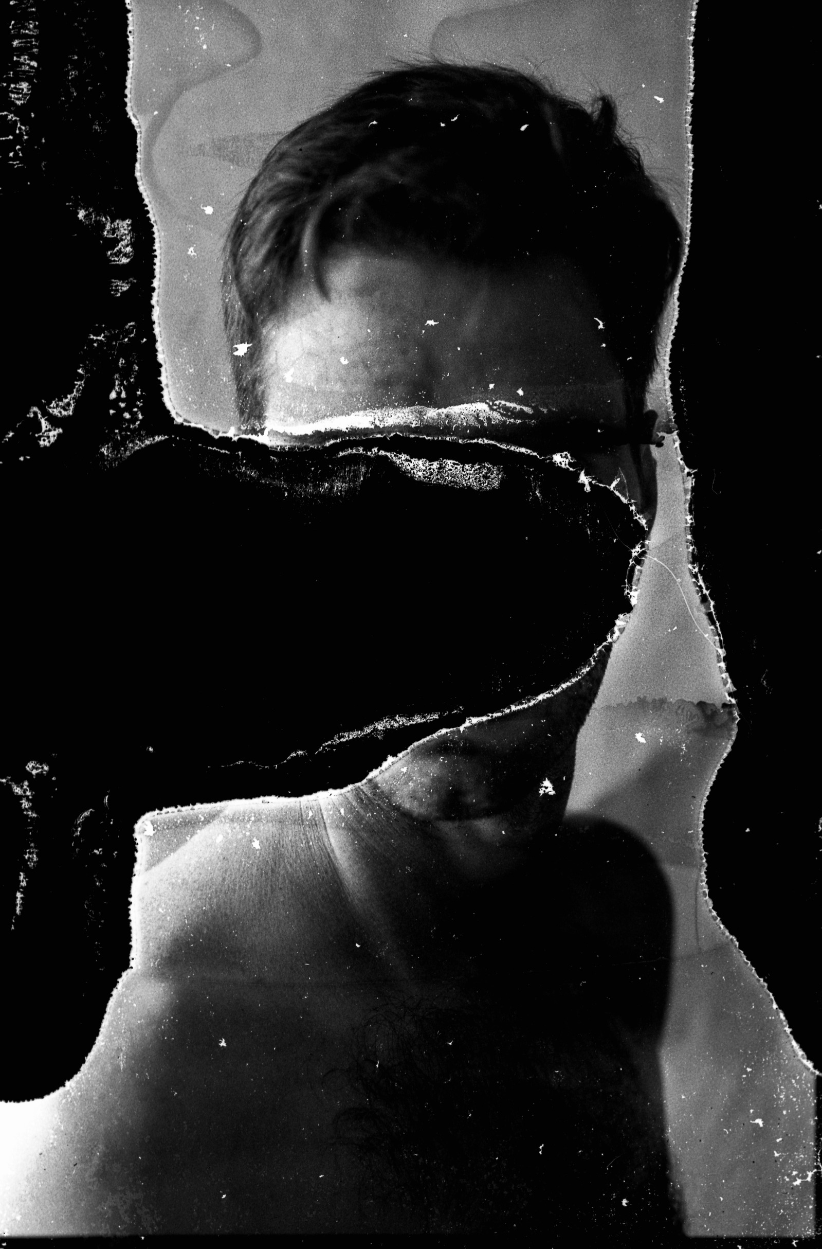 Self-portrait shot on black and white film. Prior to exposure, the film was soaked for two days in a solution containing dissolved instant coffee and two doses of sertraline (a reuptake serotonin inhibitor used to treat anxiety and depression).