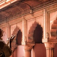 A Muslim Man Praying at Jama Masjid in Old Delhi. Photography by Andrew Adams