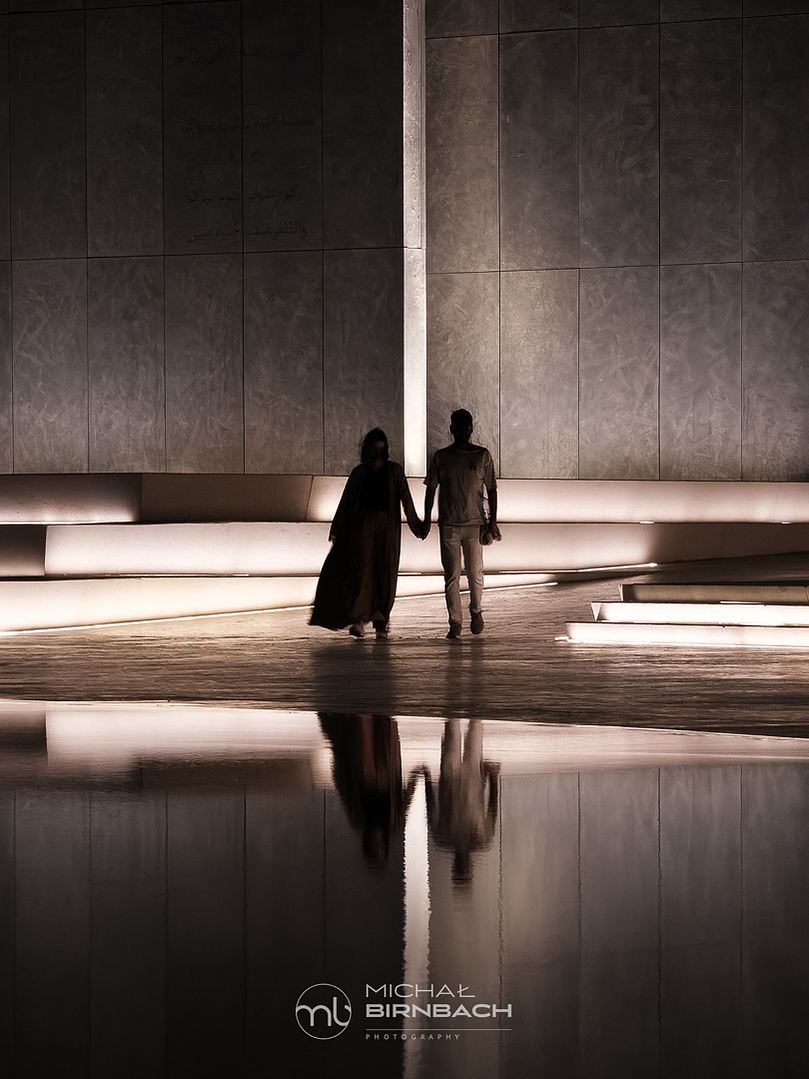 A couple in love walking near the Wahat Al Karama monument in Abu Dhabi. Travel photography. Street photography. 