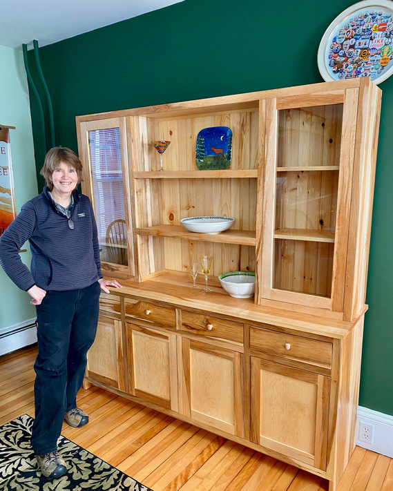 This is Me, Standing next to a maple cabinet I built - the day we delivered it. I called the cabinet Whisper, as the lines in the wood were whispering, similar to a painting. Its a beautiful piece of art.