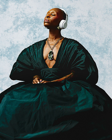 Cythia Erivo wearing Beats headphones with her eyes closed 