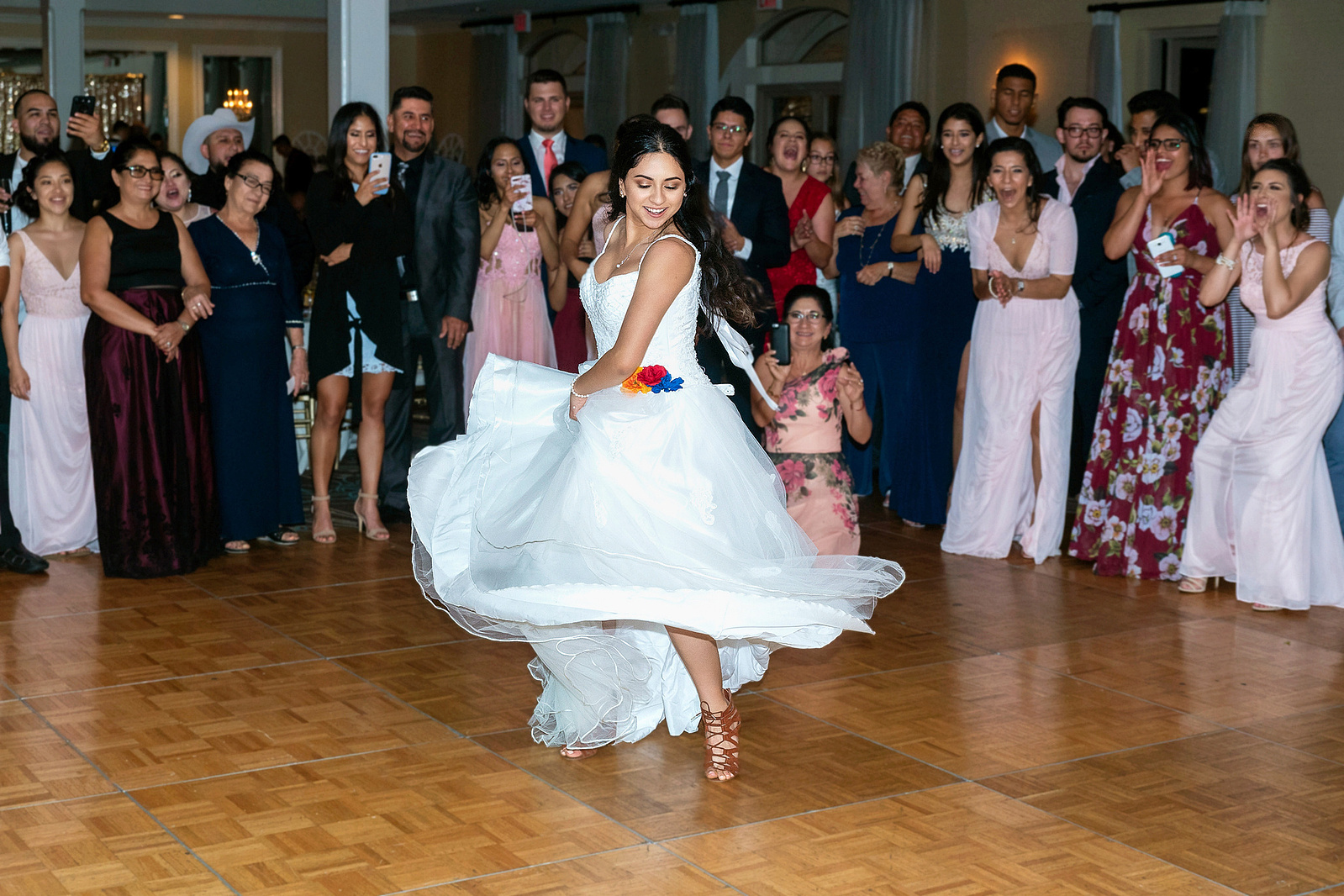 Latina bride dancing at wedding ceremony at the Marina Village Conference Center in Mission Bay in San Diego, California.