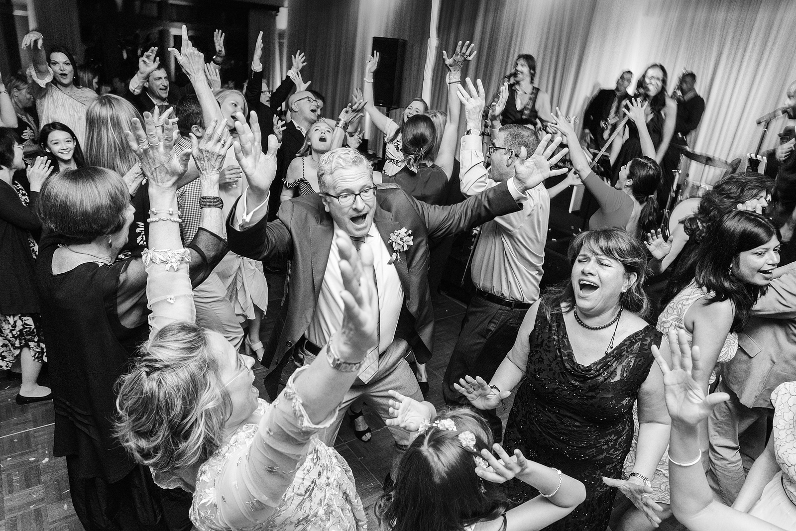 Best man and group dancing at wedding reception at Torrey Pines Lodge in San Diego, California in black and white.