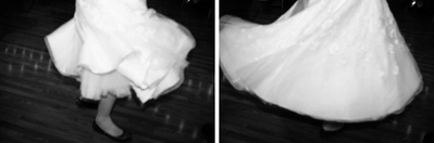 Wedding dress in black and white, spinning and swirling with motion blur as bride dances.