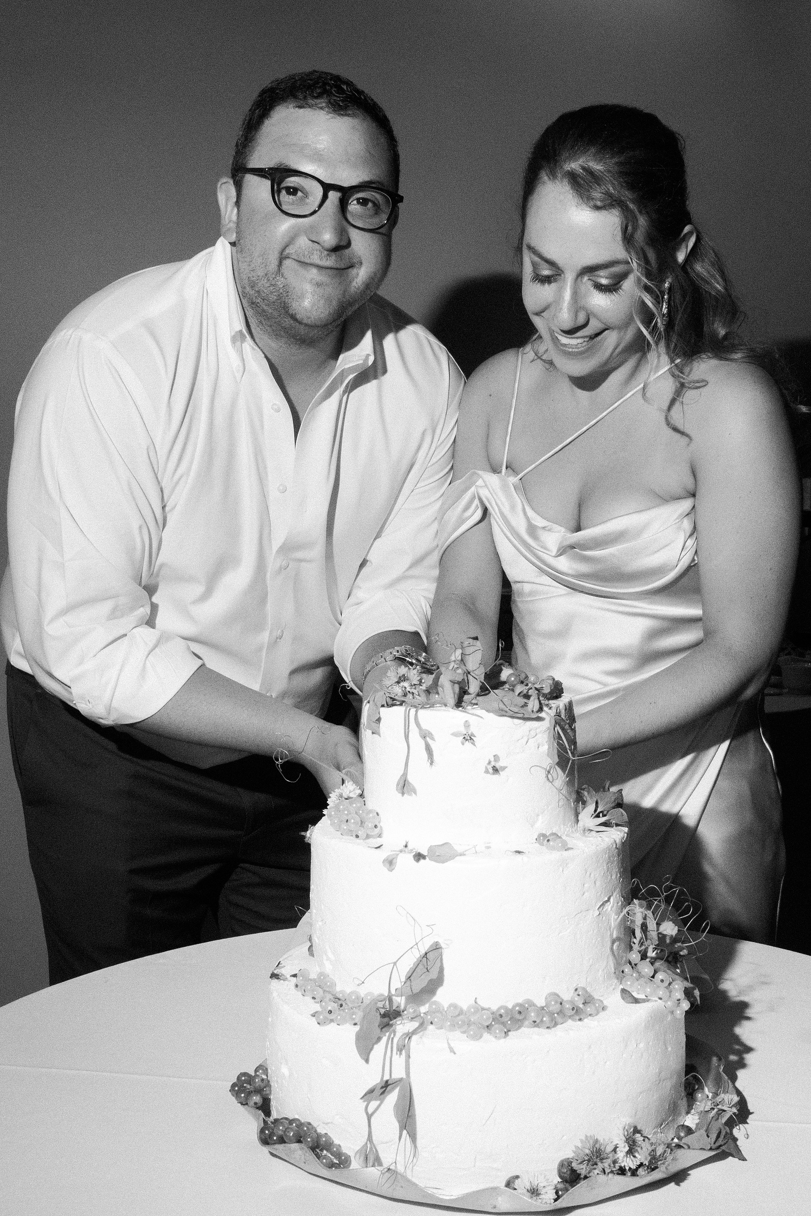 Bride and Groom cut the cake. Wedding photojournalism at Senate Garage in Kingston, NY.