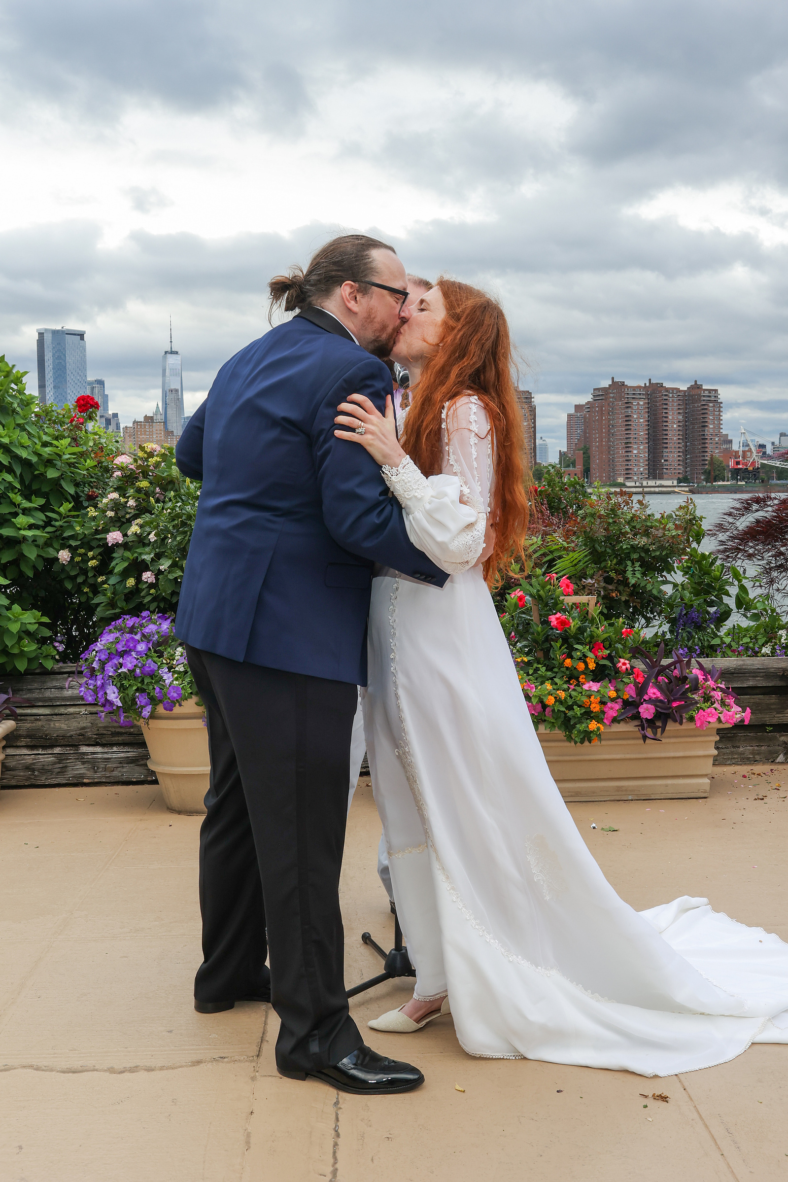 Couple kiss at end of wedding ceremony. Wedding photojournalism at Giando on the Water in Brooklyn, NY. 