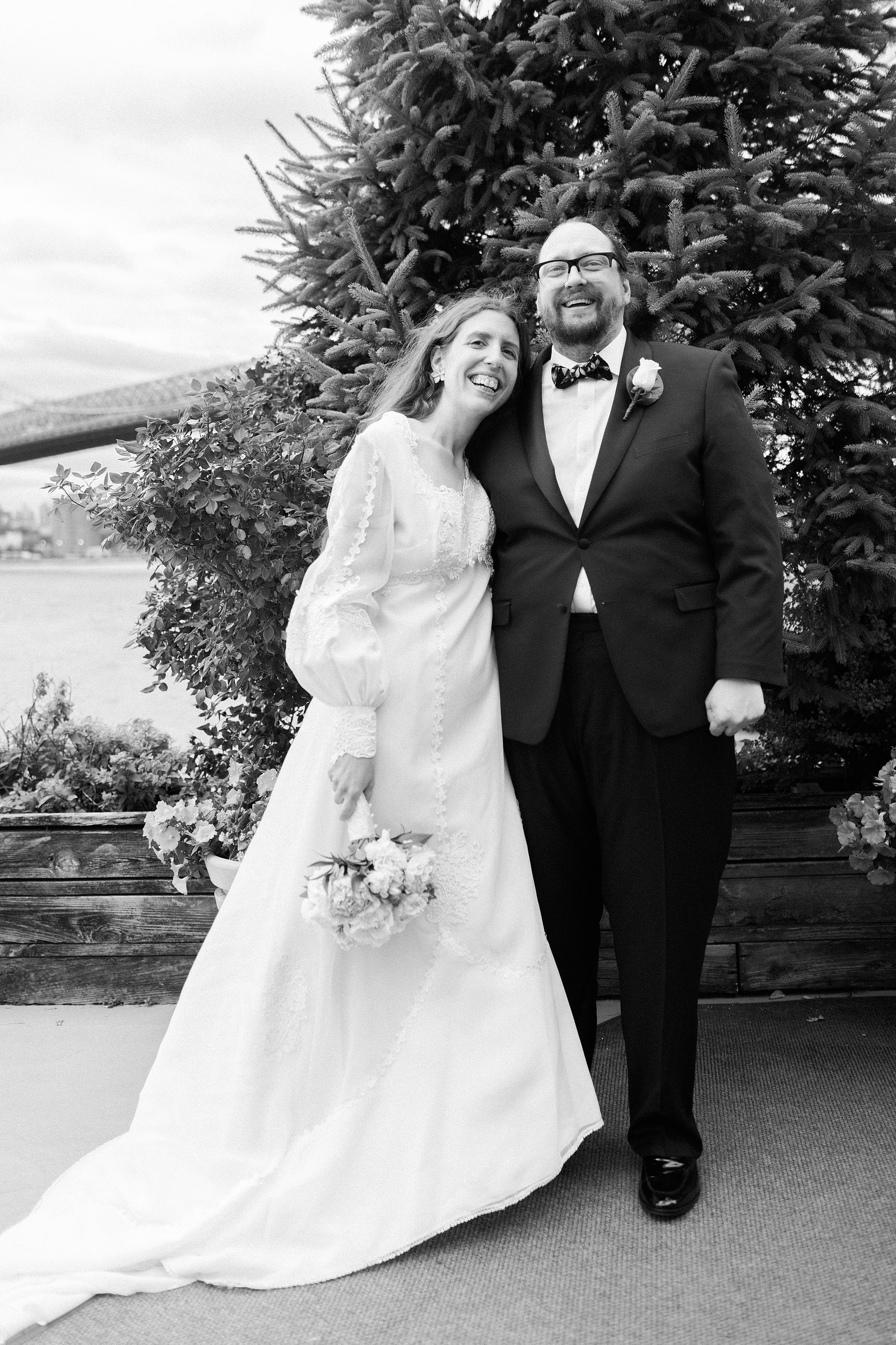 Bride and Groom posed for portrait, looking directly at camera. Wedding photojournalism at Giando on the Water in Brooklyn, NY. 