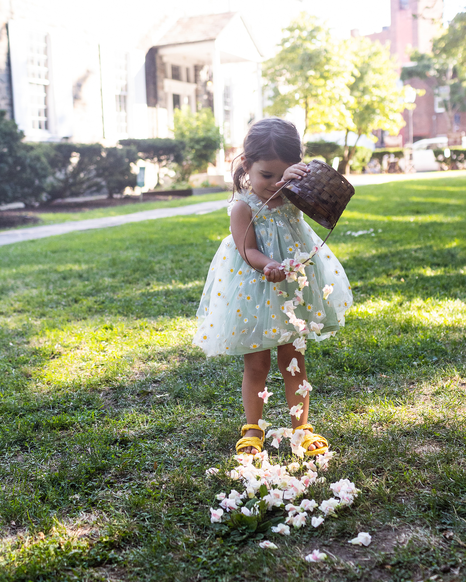 Flowergirl empties flowers at top of aisle. Wedding photojournalism at Senate Garage in Kingston, NY.