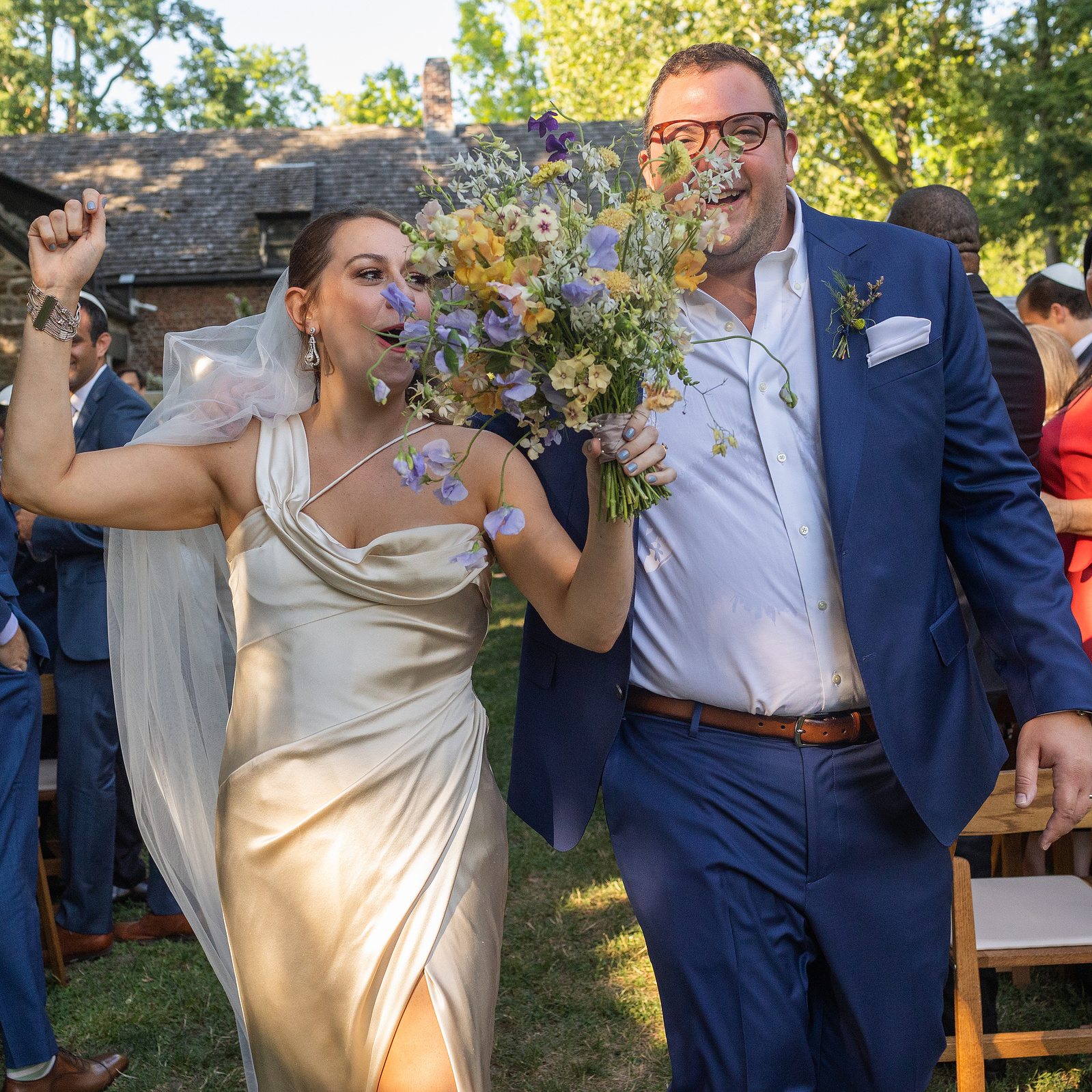 Bride and groom run down the aisle at end of ceremony. Wedding photojournalism at Senate Garage in Kingston, NY.