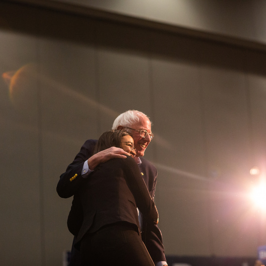 Bernie Sanders and Alexandria Ocasio-Cortez embrace on stage in Iowa during the Presidential Primary in 2020.