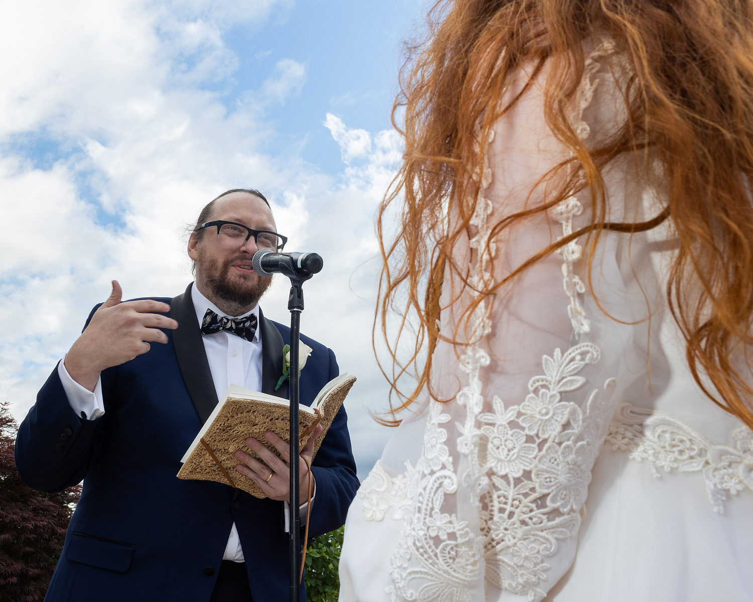 Groom and bride's arm and red hair at wedding ceremony. Wedding photojournalism at Giando on the Water in Brooklyn, NY. 