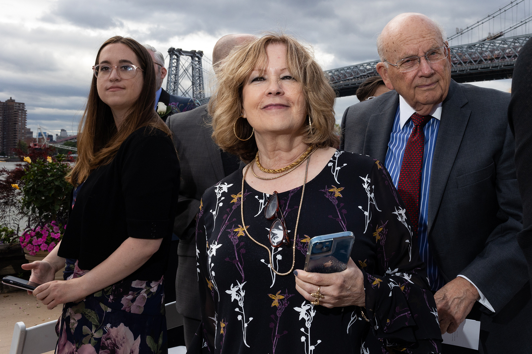 Wedding guests at ceremony site. Wedding photojournalism at Giando on the Water in Brooklyn, NY. 