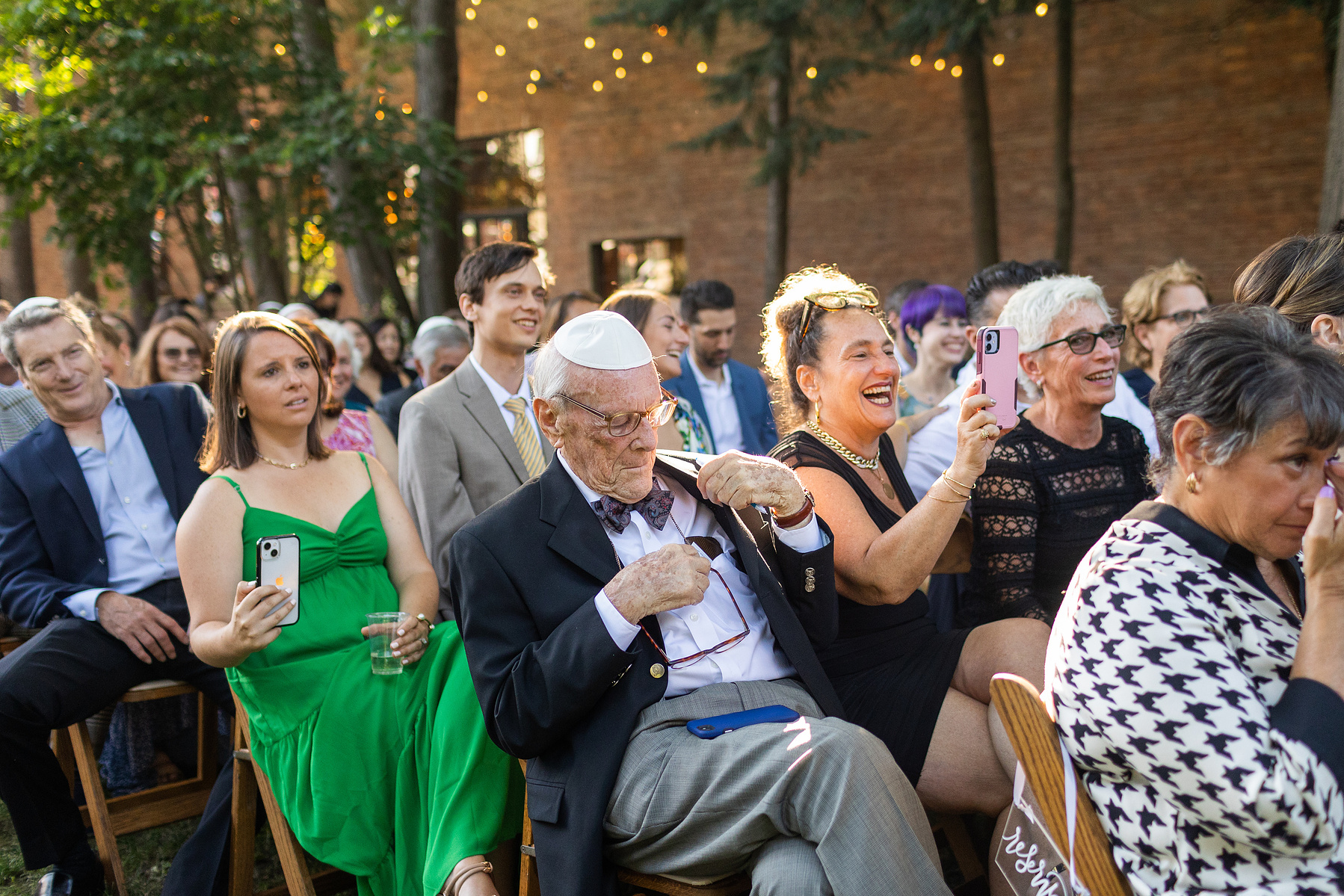 Wedding guests at ceremony. Wedding photojournalism at Senate Garage in Kingston, NY.