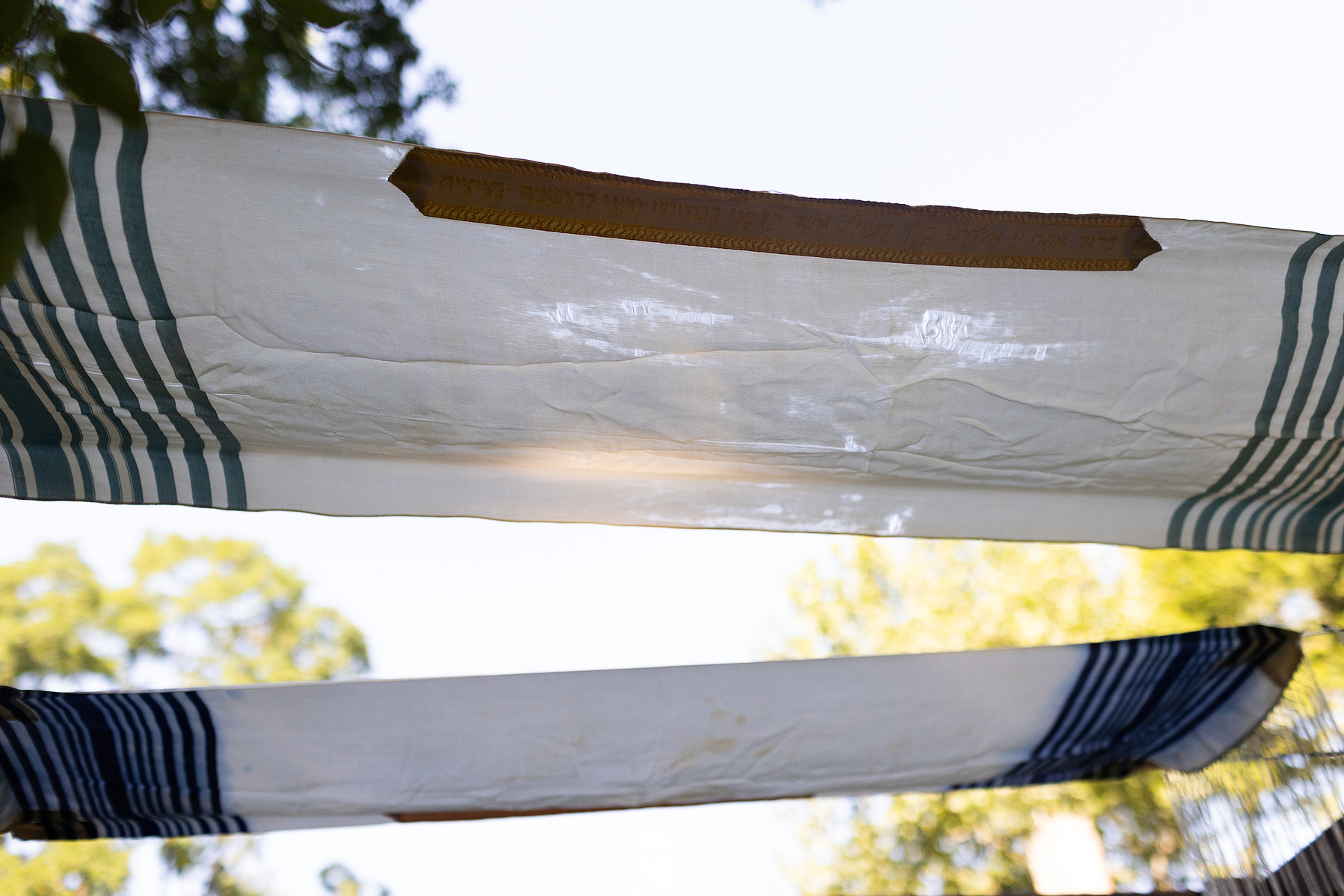 Two tallit make a chupa. Wedding photojournalism at Senate Garage in Kingston, NY.