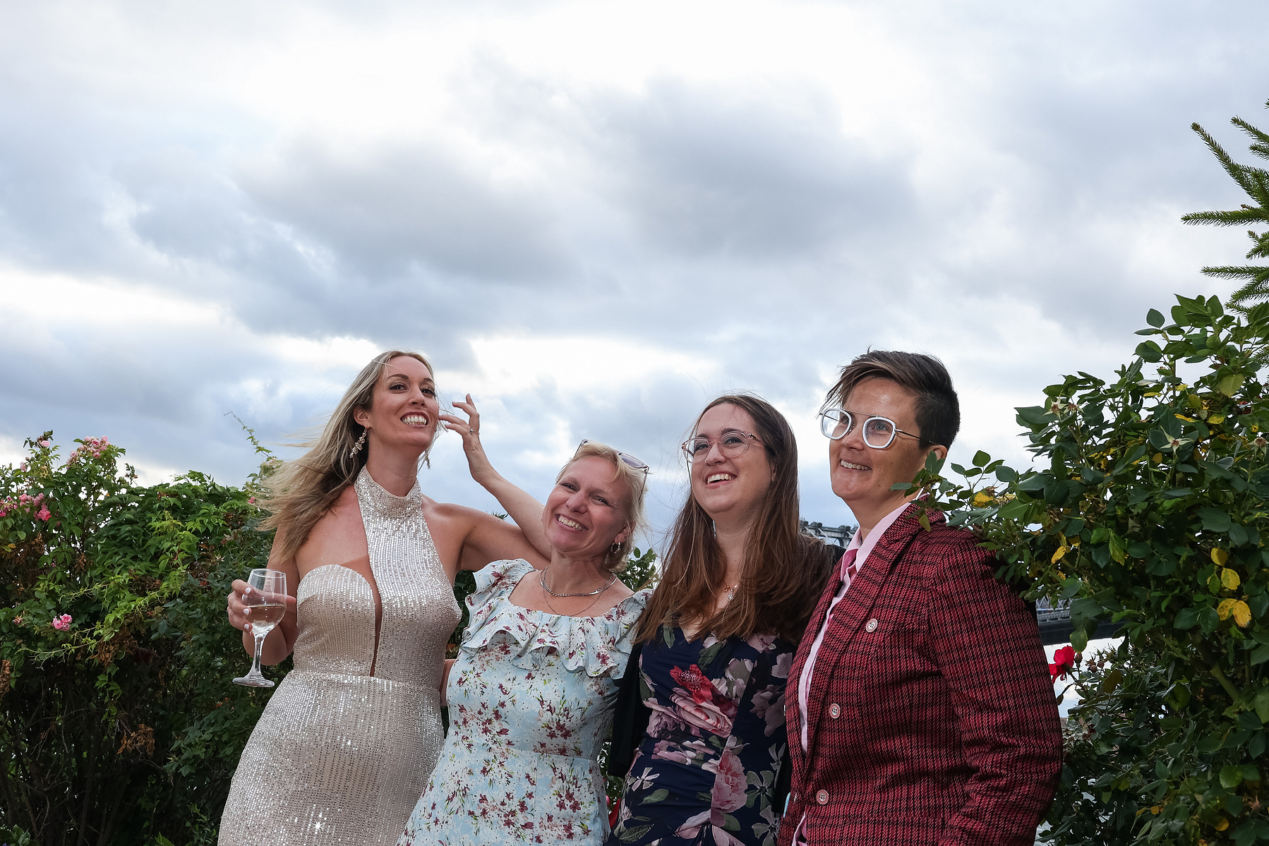 Four wedding guests pose for photo outside. Wedding photojournalism at Giando on the Water in Brooklyn, NY. 
