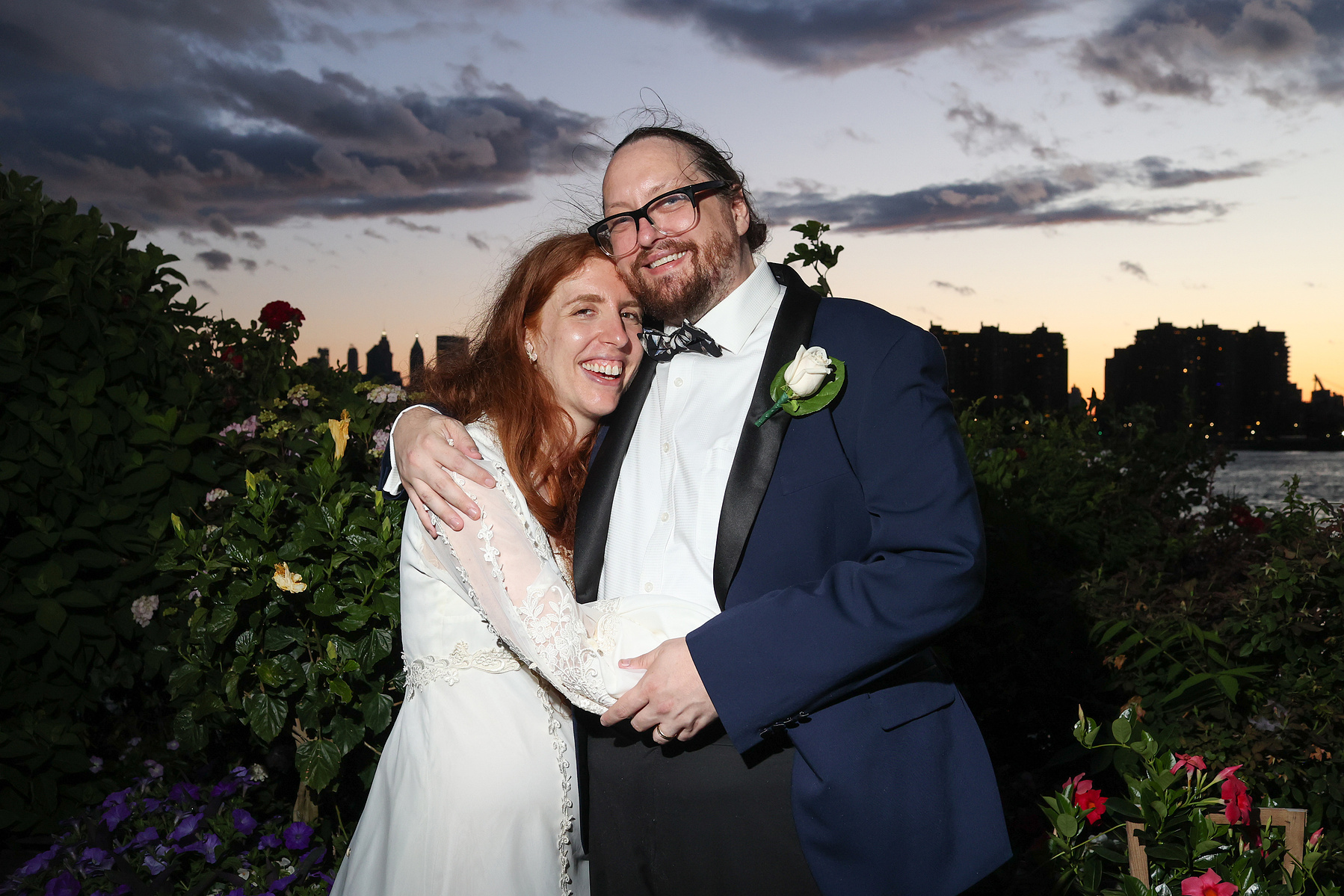 Bride and groom outside at sunset with direct flash. Wedding photojournalism at Giando on the Water in Brooklyn, NY. 