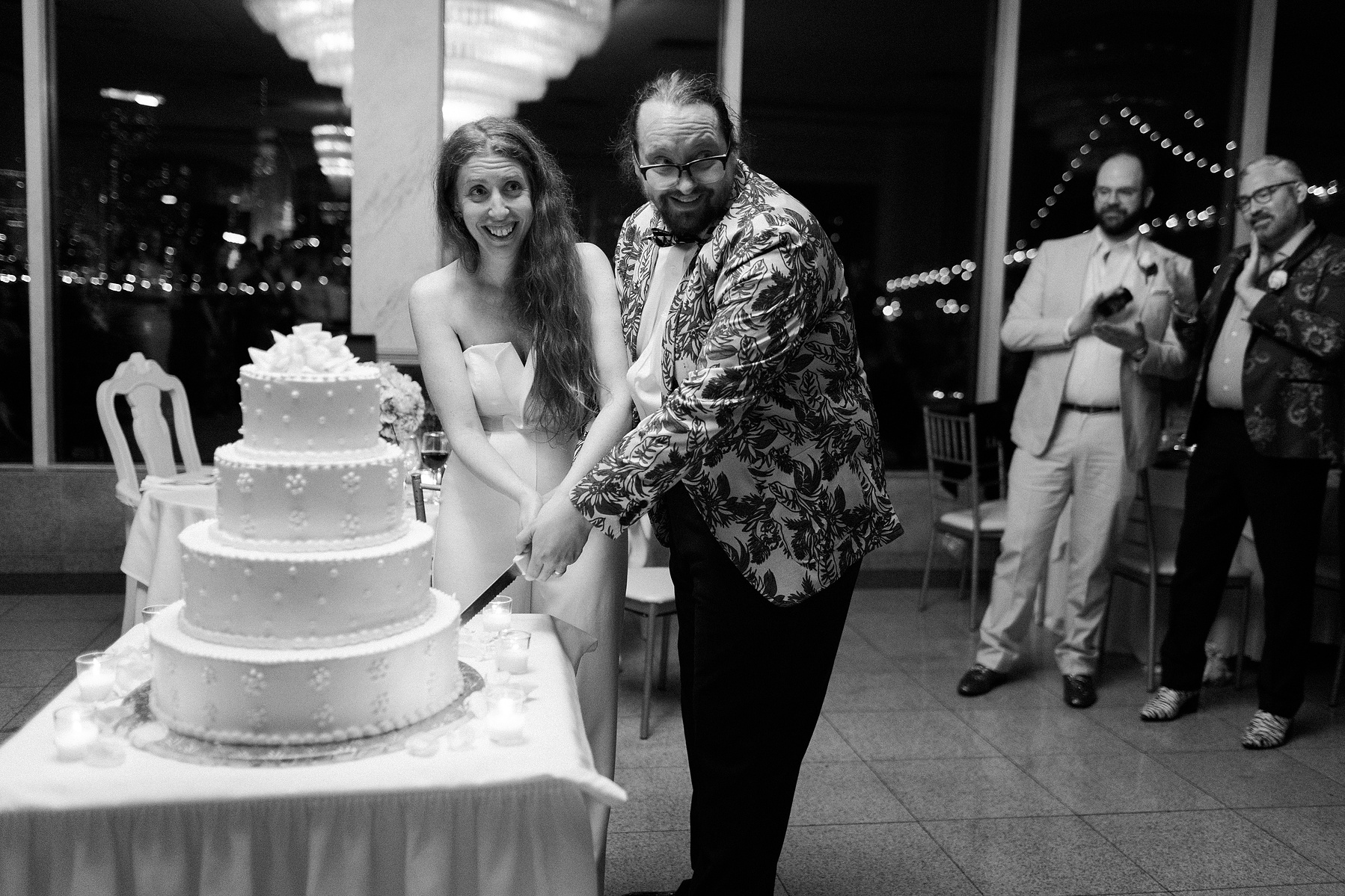 Bride and Groom cut cake at reception. Wedding photojournalism at Giando on the Water in Brooklyn, NY. 