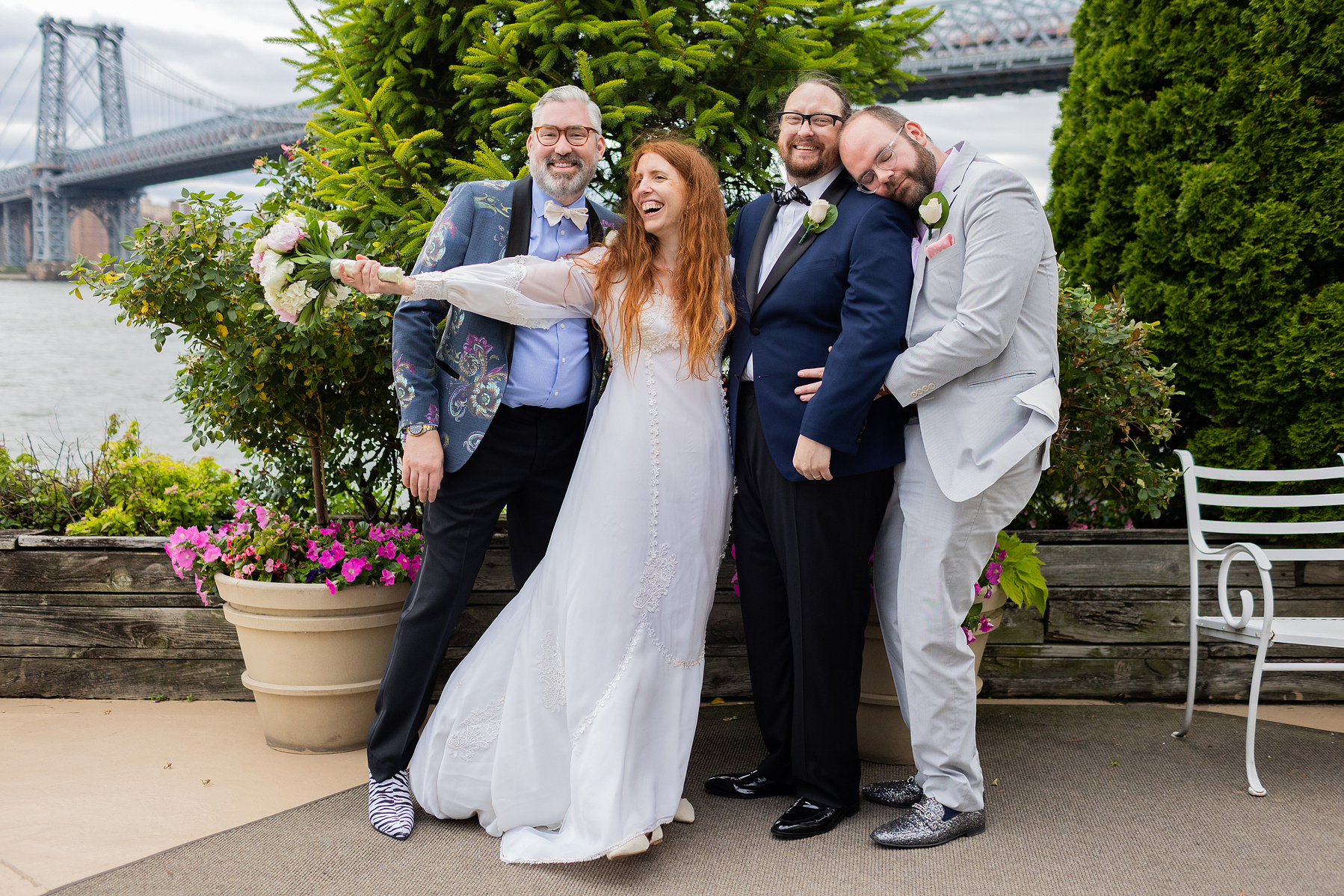 Group portrait. Officiant's partner, Bride, Groom, Officiant. Wedding photojournalism at Giando on the Water in Brooklyn, NY. 