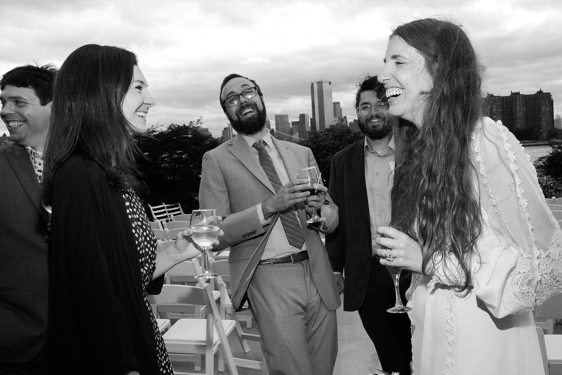 Bride with wedding guests after ceremony. Wedding photojournalism at Giando on the Water in Brooklyn, NY. 