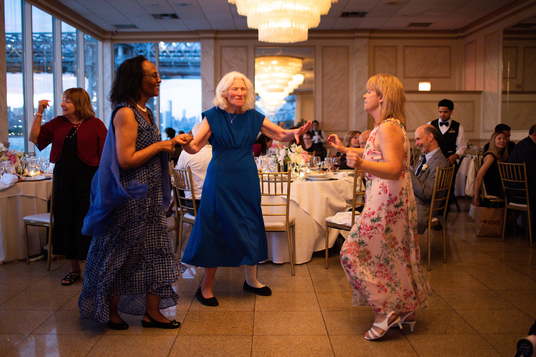 Wedding guests dance. Wedding photojournalism at Giando on the Water in Brooklyn, NY. 