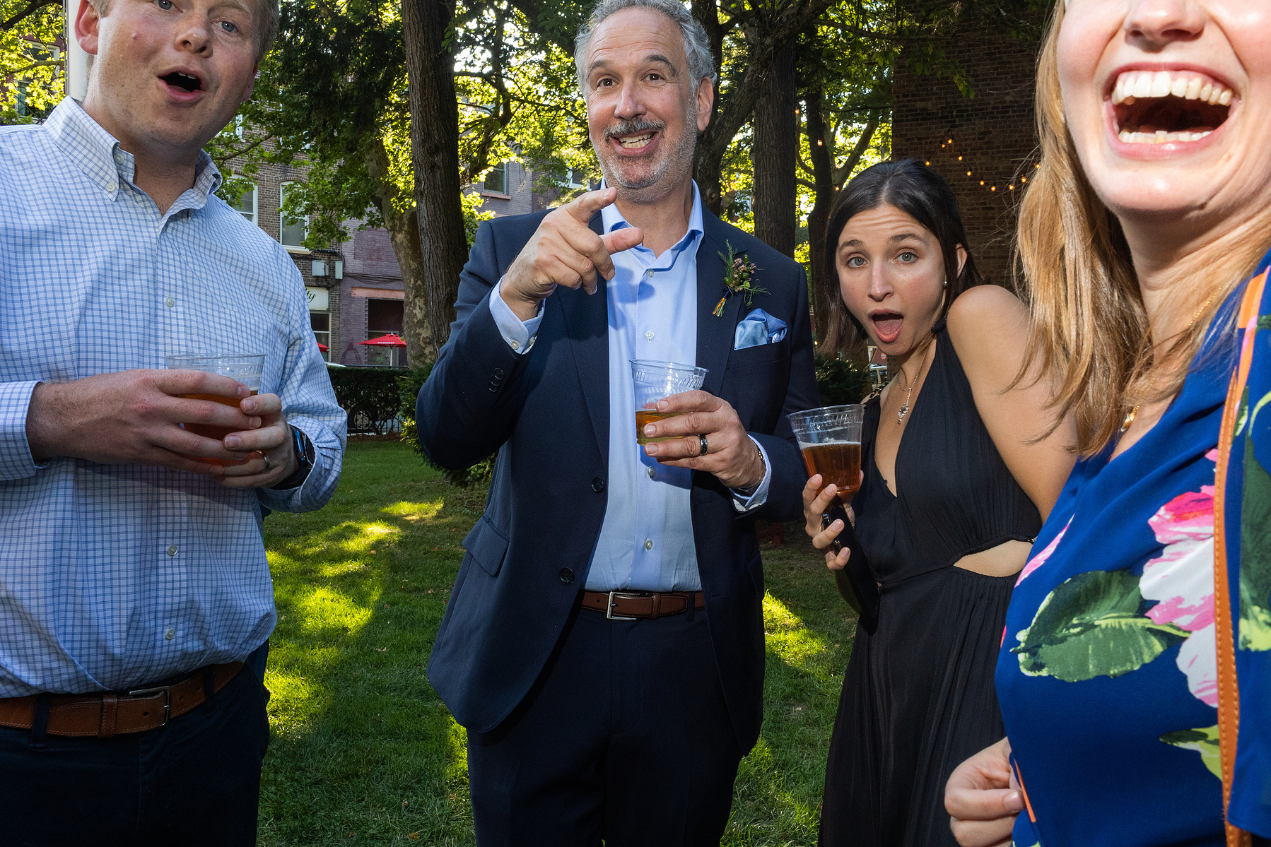 Wedding guest laugh at cocktail hour. Wedding photojournalism at Senate Garage in Kingston, NY.