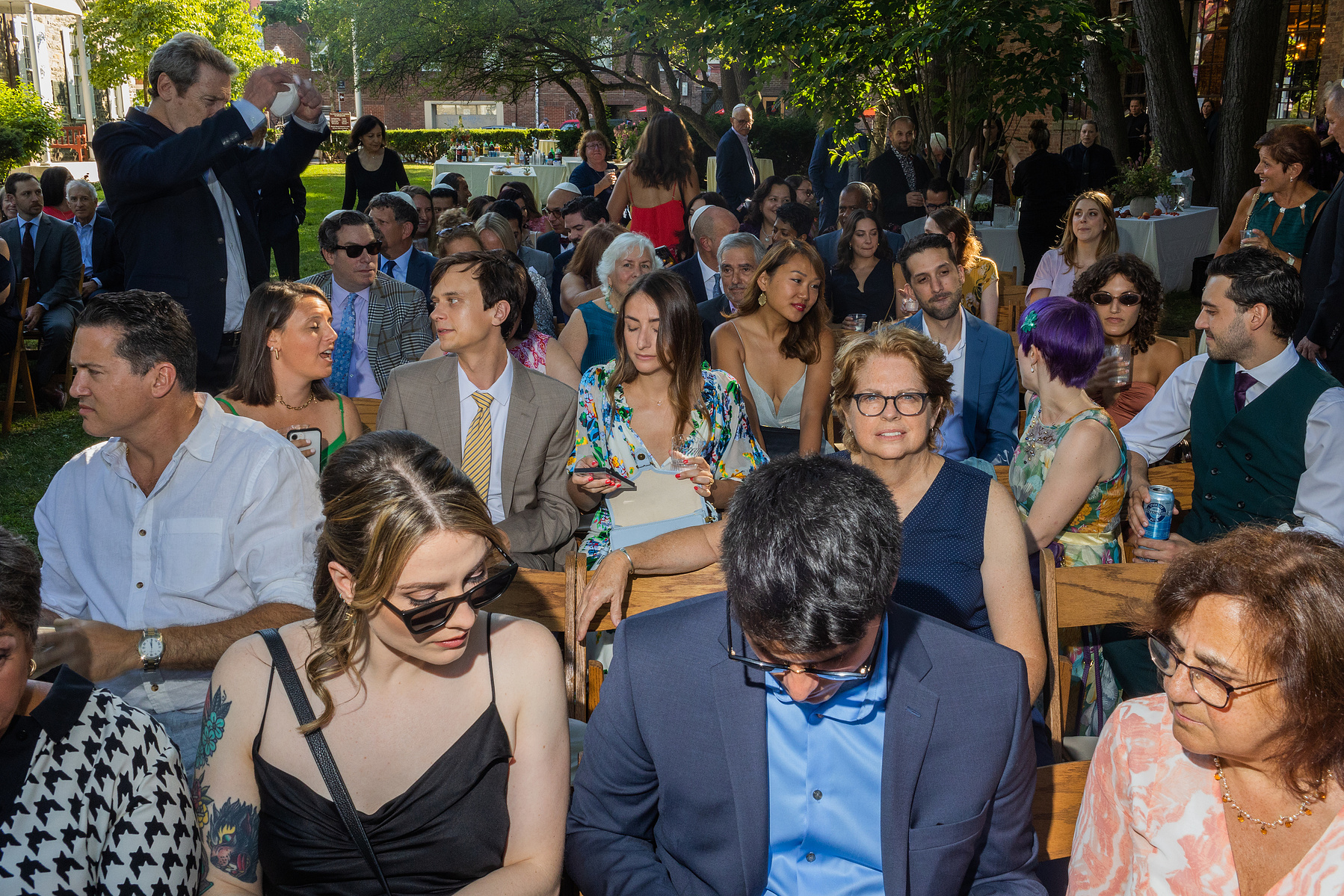 Overview of wedding guests at ceremony. Wedding photojournalism at Senate Garage in Kingston, NY.