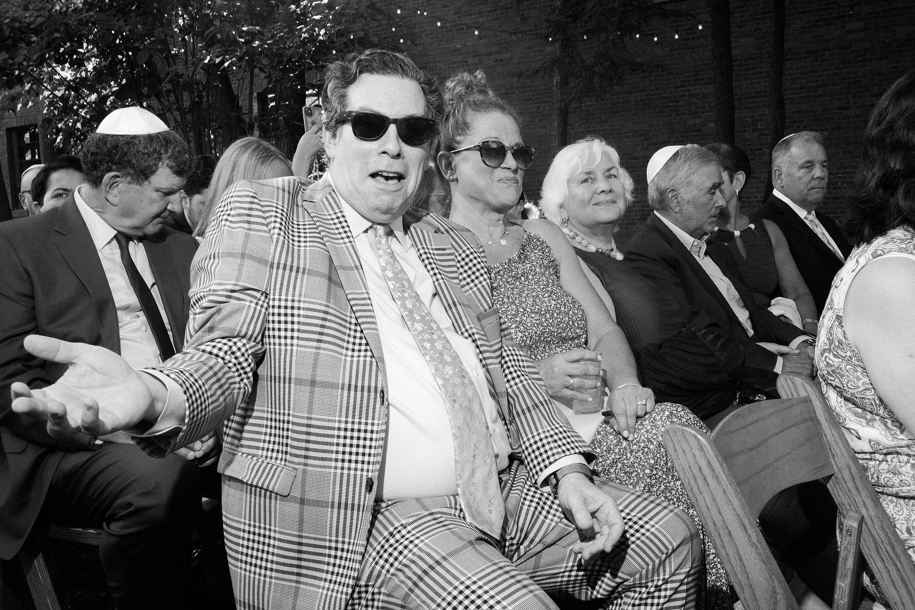 Wedding guest looks directly at camera. Wedding photojournalism at Senate Garage in Kingston, NY.
