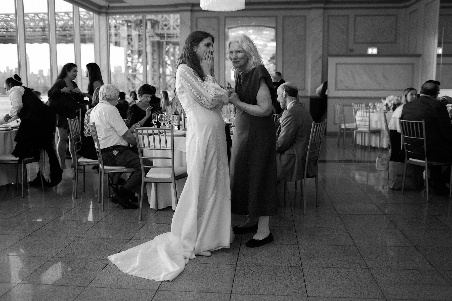 Bride and mother at reception. Wedding photojournalism at Giando on the Water in Brooklyn, NY. 