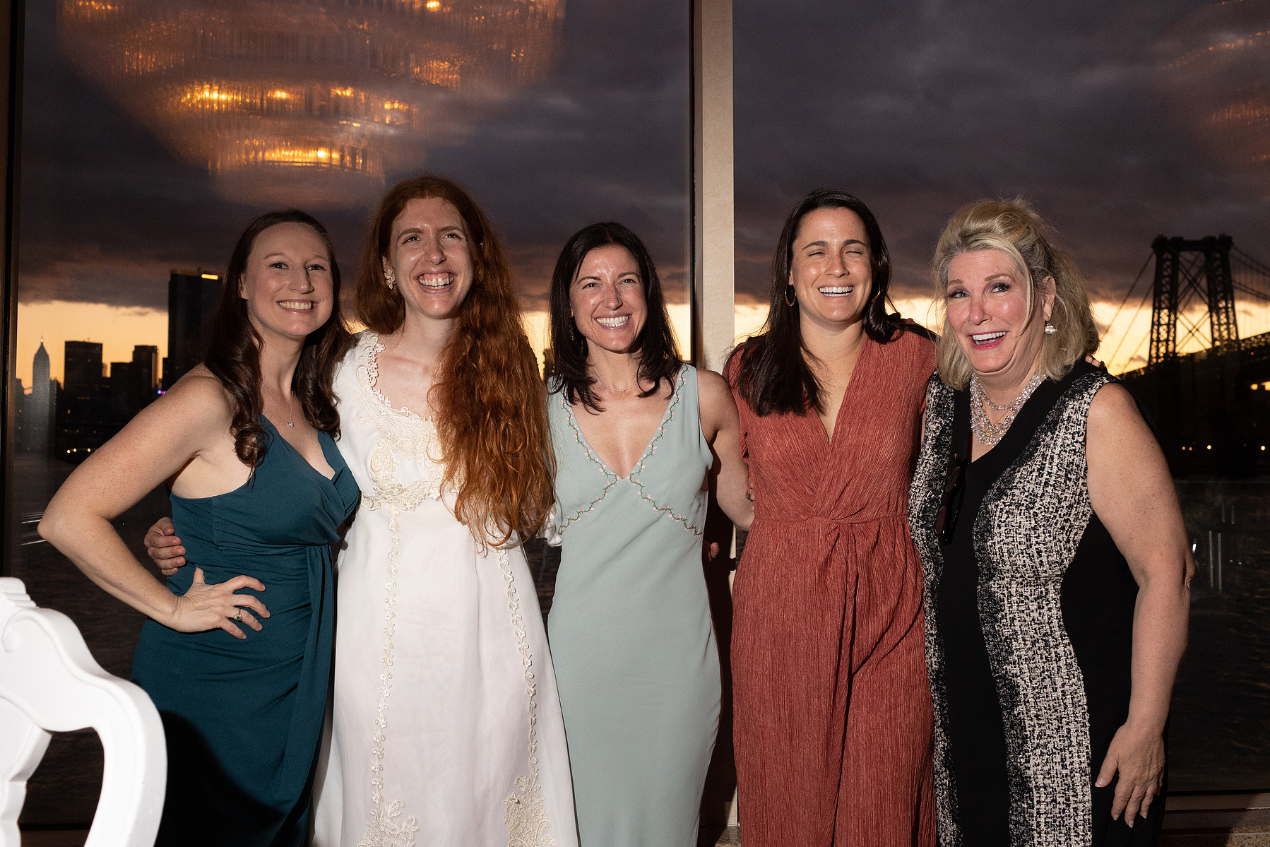Four wedding guests pose with bride. Wedding photojournalism at Giando on the Water in Brooklyn, NY. 