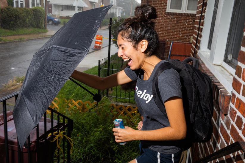 Alexandra Rojas, Justice Democrats, waits out a sudden downpour while canvassing for Kerri Evelyn Harris in Wilmington, DE.