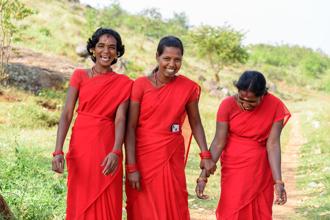 Three village women in red saree laughing