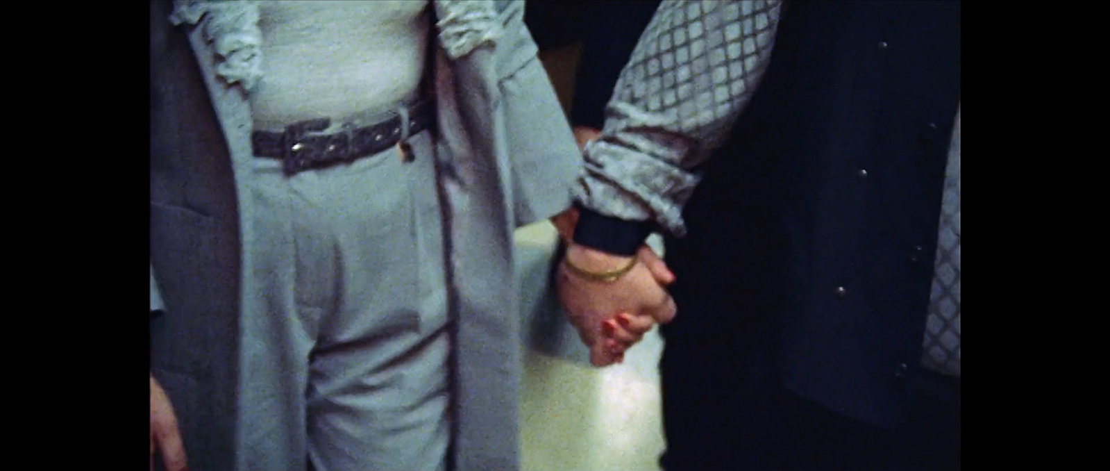 Still from John Appel's documentary 'Zij Gelooft in Mij' showing Rachel and André hand in hand.